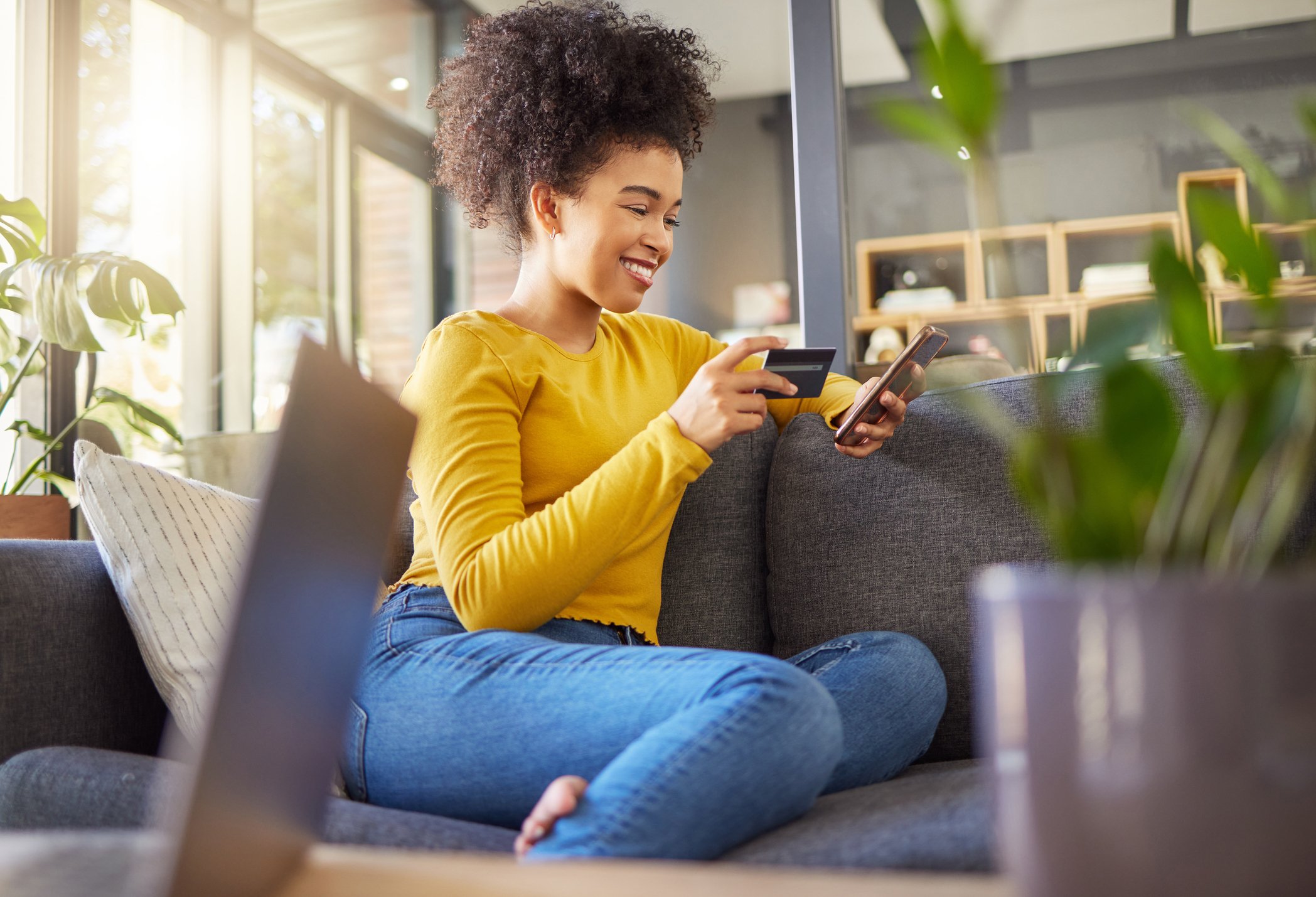 Young woman placing online order on smart phone