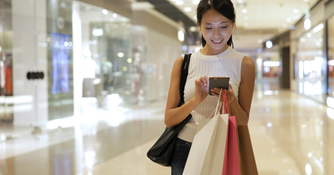 omnichannel retail shopper in mall on phone